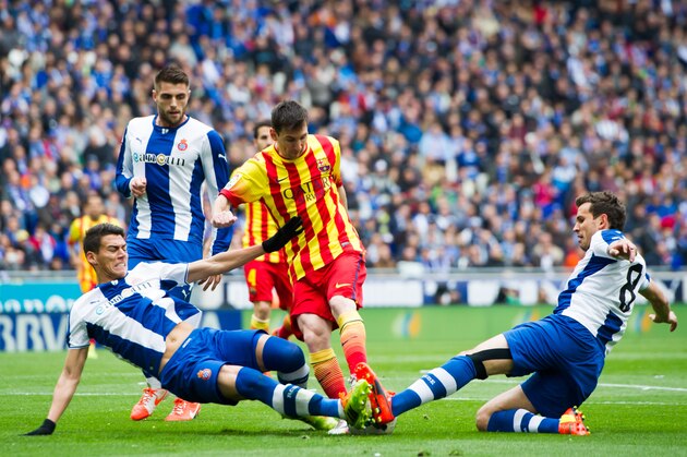 BARCELONA, SPAIN - MARCH 29: Hector Moreno (L) and Cristhian Stuani (R) of RCD Espanyol fight for the ball with Lionel Messi (C) of FC Barcelona during the La Liga match between RCD Espanyol and FC Barcelona at Cornella-El Prat Stadium on March 29, 2014 in Barcelona, Spain. (Photo by Alex Caparros/Getty Images)