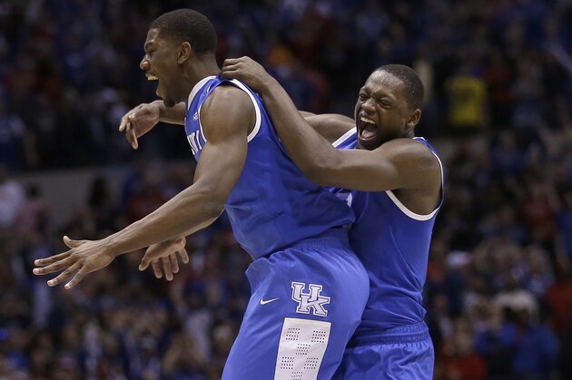 Kentucky's Alex Poythress and Aaron Harrison celebrate after an NCAA Midwest Regional semifinal college basketball tournament game against the Louisville Saturday, March 29, 2014, in Indianapolis. Kentucky won 74-69. (AP Photo/David J. Phillip)
