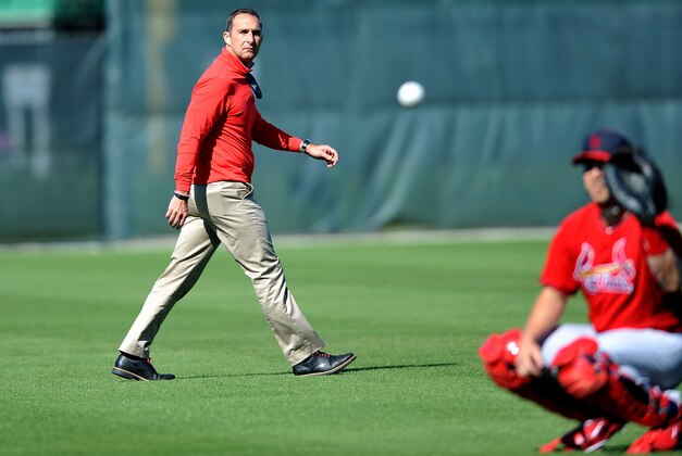 Feb 16, 2014; Jupiter, FL, USA;  St. Louis Cardinals general manager John Mozeliak (left) walks in the outfield during spring training at Roger Dean Stadium. Mandatory Credit: Steve Mitchell-USA TODAY Sports