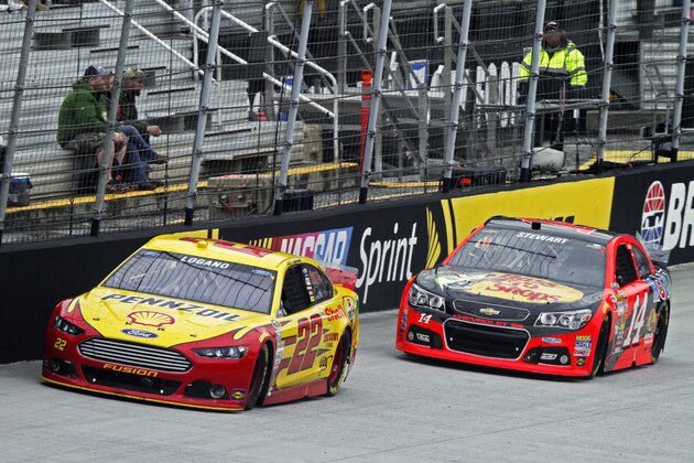 Driver Joey Logano (22) leads Tony Stewart (14) during the NASCAR Sprint Cup series auto race at Bristol Motor Speedway on Sunday, March 16, 2014, in Bristol, Tenn. (AP Photo/Wade Payne)