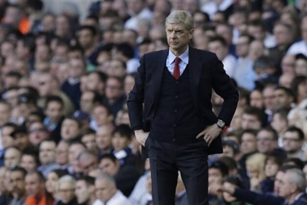 Arsenal's manager Arsene Wenger watches his team play from the technical area during the English Premier League soccer match between Tottenham Hotspur and Arsenal at White Hart Lane stadium in London, Sunday, March 16, 2014. (AP Photo/Matt Dunham)