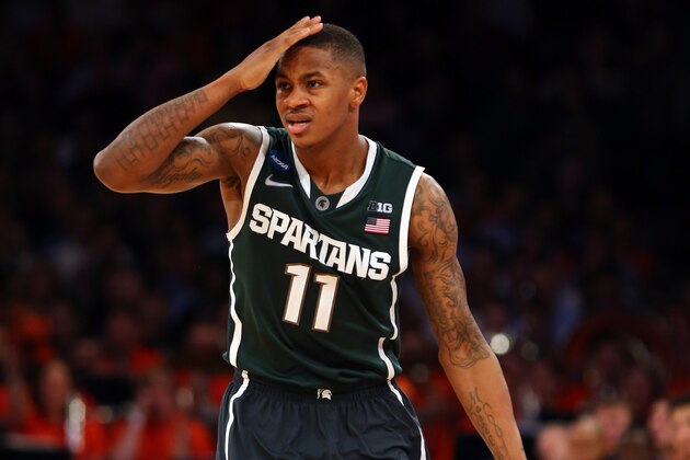 NEW YORK, NY - MARCH 28:  Keith Appling #11 of the Michigan State Spartans gestures as he bring the ball up the court against the Virginia Cavaliers during the regional semifinal of the 2014 NCAA Men's Basketball Tournament at Madison Square Garden on March 28, 2014 in New York City.  (Photo by Elsa/Getty Images)