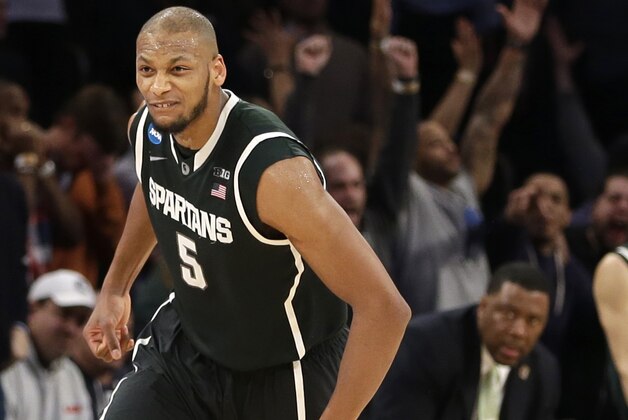 Michigan State's Adreian Payne celebrates after scoring in the second half of a regional semifinal against Virginia at the NCAA men's college basketball tournament, early Saturday, March 29, 2014, in New York. Michigan State won 61-59. (AP Photo/Seth Wenig)