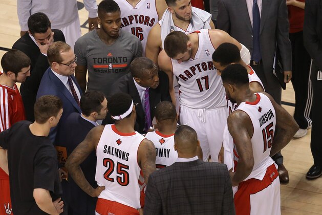 Mar 21, 2014; Toronto, Ontario, CAN; Toronto Raptors head coach Dwane Casey talks to center Jonas Valanciunas (17) and guard DeMar DeRozan (10) and point guard Kyle Lowry (7) and forward Amir Johnson (15) against the Oklahoma City Thunder at Air Canada Centre. The Thunder beat the Raptors 119-118 in double overtime. Mandatory Credit: Tom Szczerbowski-USA TODAY Sports