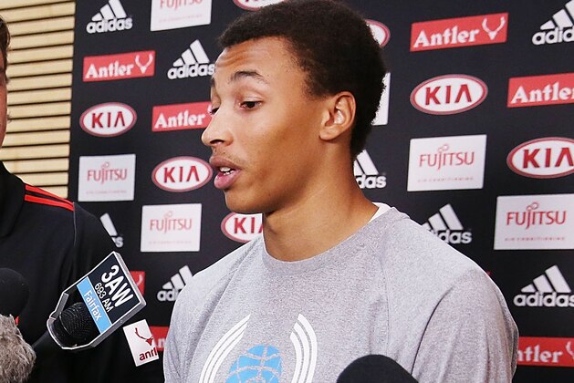 MELBOURNE, AUSTRALIA - FEBRUARY 14:  Young Australian basketball player Dante Exum (R) and Joe Daniher of the Bombers  speak during an Essendon Bombers AFL media session at True Value Solar Centre on February 14, 2014 in Melbourne, Australia.  (Photo by Michael Dodge/Getty Images)