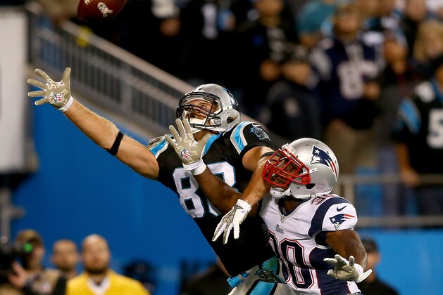 CHARLOTTE, NC - NOVEMBER 18:  Tight end Greg Olsen #88 of the Carolina Panthers goes up for a catch against defensive back Duron Harmon #30 of the New England Patriots in the first half at Bank of America Stadium on November 18, 2013 in Charlotte, North Carolina.  (Photo by Streeter Lecka/Getty Images)