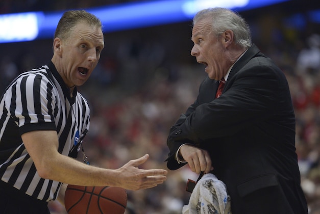 Mar 29, 2014; Anaheim, CA, USA; Wisconsin Badgers head coach Bo Ryan (right) argues with NCAA official Mike Eades (left) during the first half in the finals of the west regional of the 2014 NCAA Mens Basketball Championship tournament against the Arizona Wildcats at Honda Center. Mandatory Credit: Robert Hanashiro-USA TODAY Sports