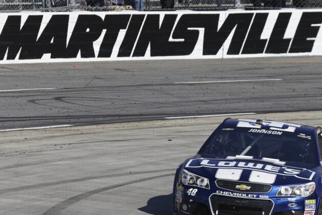 Sprint Cup Series driver Jimmie Johnson (48) drives through turn four during the NASCAR Sprint Cup  auto race at Martinsville Speedway in Martinsville, Va., Sunday, Oct. 27, 2013. (AP Photo/Steve Helber)