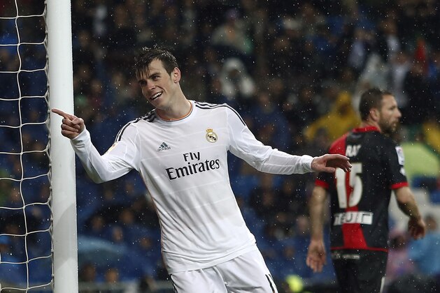 Real's Gareth Bale, left, celebrates his goal during a Spanish La Liga soccer match between Real Madrid and Rayo Vallecano at the Santiago Bernabeu stadium in Madrid, Spain, Saturday, March 29, 2014. (AP Photo/Andres Kudacki)