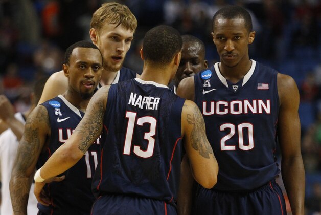 Connecticut guard Shabazz Napier (13) talks with Ryan Boatright (11), Niels Giffey (5) and Lasan Kromah (20) during the second half of a third-round game in the NCAA men's college basketball tournament in Buffalo, N.Y., Saturday, March 22, 2014. Connecticut defeated Villanova, 77-65. (AP Photo/Bill Wippert)
