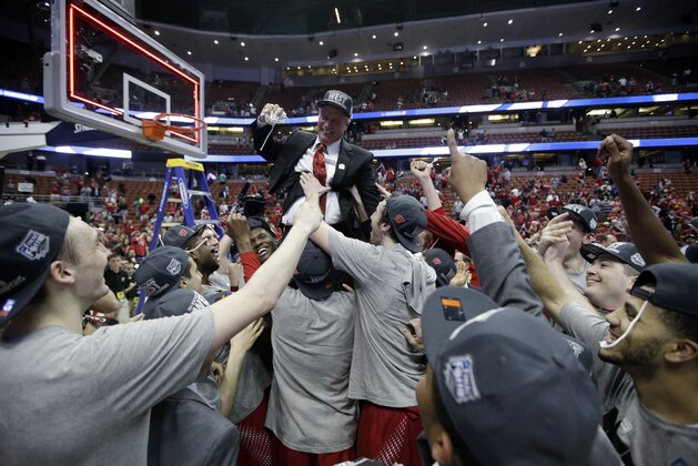 Players lift Wisconsin head coach Bo Ryan after a regional final NCAA college basketball tournament game against Arizona, Saturday, March 29, 2014, in Anaheim, Calif. Wisconsin won 64-63 in overtime. (AP Photo/Jae C. Hong)