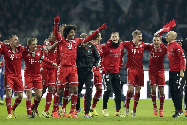 Bayern's Arjen Robben of the Netherlands, right, Bayern's Franck Ribery of France, left, and their teammates celebrate winning the German soccer championship after the German Bundesliga soccer match between Hertha BSC Berlin and Bayern Munich in Berlin, Germany, Tuesday, March 25, 2014. (AP Photo/Michael Sohn)