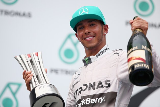 KUALA LUMPUR, MALAYSIA - MARCH 30:  Race winner Lewis Hamilton of Great Britain and Mercedes GP celebrates on the podium after the Malaysia Formula One Grand Prix at the Sepang Circuit on March 30, 2014 in Kuala Lumpur, Malaysia.  (Photo by Clive Mason/Getty Images)