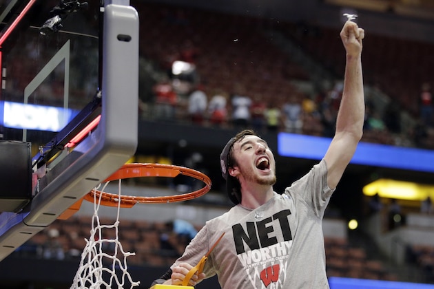 Wisconsin 's Frank Kaminsky cuts down the net after a regional final NCAA college basketball tournament game against Arizona, Saturday, March 29, 2014, in Anaheim, Calif. Wisconsin won 64-63 in overtime. (AP Photo/Jae C. Hong)