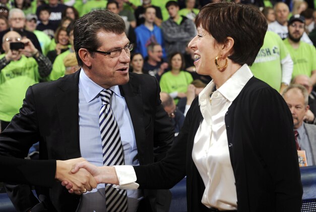 FILE - In this March 4, 2013, file photo, Connecticut head coach Geno Auriemma, left, shakes hands with Notre Dame head coach Muffet McGraw before an NCAA college basketball game in South Bend, Ind. McGraw and Auriemma have been crossing paths for years. They meet again Sunday in a national semifinal game in New Orleans, at the Women's Final Four of the NCAA college basketball tournament. (AP Photo/Joe Raymond, File)