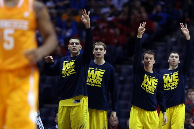 INDIANAPOLIS, IN - MARCH 28:  The Michigan Wolverines bench reacts to a three pointer in the second half against the Tennessee Volunteers during the regional semifinal of the 2014 NCAA Men's Basketball Tournament at Lucas Oil Stadium on March 28, 2014 in Indianapolis, Indiana.  (Photo by Jonathan Daniel/Getty Images)