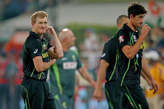 DHAKA, BANGLADESH - MARCH 30:  George Bailey and Mitchell Starc of Australia leave the field after losing the ICC World Twenty20 Bangladesh 2014 match between India v Australia at Sher-e-Bangla Mirpur Stadium on March 30, 2014 in Dhaka, Bangladesh.  (Photo by Scott Barbour/Getty Images)