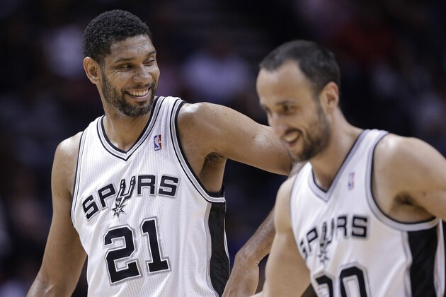 San Antonio Spurs' Tim Duncan (21) celebrates with Manu Ginobili (20) during the second half of an NBA basketball game against the Denver Nuggets, Wednesday, March 26, 2014, in San Antonio. San Antonio won 108-103. (AP Photo/Eric Gay)