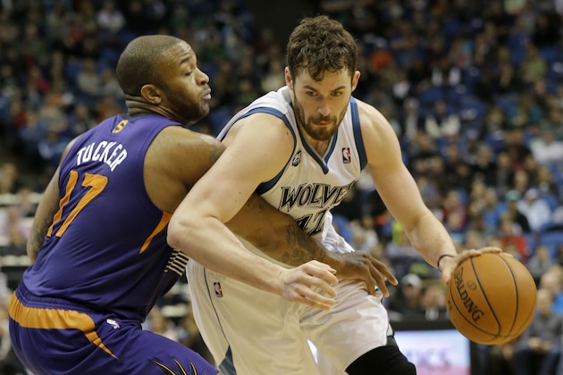 Minnesota Timberwolves forward Kevin Love, right, drives against Phoenix Suns forward P.J. Tucker (17) during the fourth quarter of an NBA basketball game in Minneapolis, Sunday, March 23, 2014. The Suns won 127-120. (AP Photo/Ann Heisenfelt)