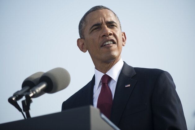 ARLINGTON, VA - SEPTEMBER 11:  11:  U.S. President Barack Obama speaks during a ceremony in observance of the terrorist attacks of 9/11 as Defense Secretary Chuck Hagel (L) and Chairman of the Joint Chiefs of Staff Gen. Martin Dempsey listen at the Pentagon September 11, 2013 in Arlington, Virginia. Family members of the Pentagon attack victims and survivors of the attack gathered to hear from Obama and other leaders at the National 9/11 Pentagon Memorial near the place where terrorists drove a jetliner into the Department of Defense headquarters in 2001.  (Photo by Kevin Dietsch-Pool/Getty Images)