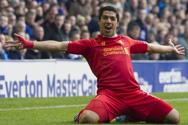 Liverpool's Luis Suarez celebrates after scoring against Everton, during their English Premier League soccer match at Goodison Park Stadium, Liverpool, England, Saturday Nov. 23, 2013. (AP Photo/Jon Super)