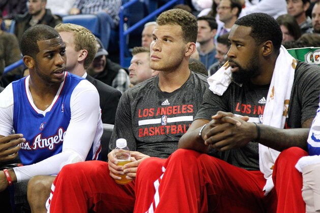 Los Angeles Clippers guard Chris Paul, left, forward Blake Griffin, center, and center DeAndre Jordan, right, talk on the bench during the first half of an NBA basketball game in New Orleans, Wednesday, March 26, 2014. (AP Photo/Jonathan Bachman)