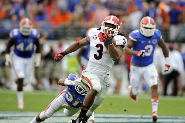 Georgia running back Todd Gurley (3) out runs Florida defensive back Cody Riggs (31) and linebacker Antonio Morrison (3) for a touchdown on a 72-yard pass play during the first half of an NCAA college football game in Jacksonville, Fla., Saturday, Nov. 2, 2013.(AP Photo/Stephen Morton) Georgia running back Todd Gurley (3) out runs Florida defensive back Cody Riggs (31) and linebacker Antonio Morrison (3) for a touchdown on a 72-yard pass play during the first half of an NCAA college football game in Jacksonville, Fla., Saturday, Nov. 2, 2013.(AP Photo/Stephen Morton)