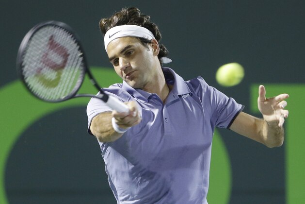 Roger Federer of Switzerland, returns a shot from Kei Nishikori of Japan, at the Sony Open Tennis tournament, Wednesday, March 26, 2014 in Key Biscayne, Fla. (AP Photo/Wilfredo Lee)