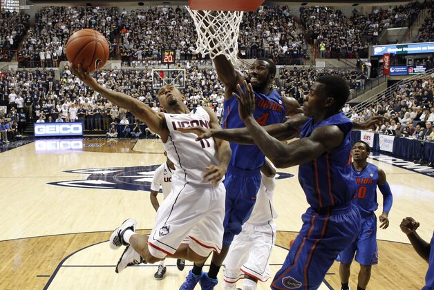 Dec 2, 2013; Storrs, CT, USA; Connecticut Huskies guard Ryan Boatright (11)  shoots against Florida Gators center Patric Young (4) in the second half at Harry A. Gampel Pavilion. UConn defeated Florida Gators 65-64.  Mandatory Credit: David Butler II-USA TODAY Sports