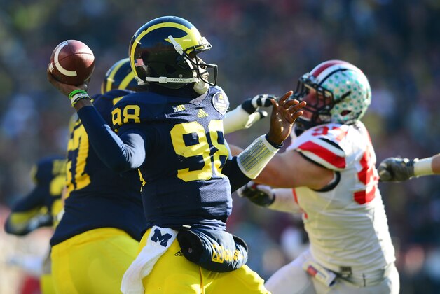 Nov 30, 2013; Ann Arbor, MI, USA; Michigan Wolverines quarterback Devin Gardner (98) throws a pass during the third quarter against the Ohio State Buckeyes at Michigan Stadium. Mandatory Credit: Andrew Weber-USA TODAY Sports Nov 30, 2013; Ann Arbor, MI, USA; Michigan Wolverines quarterback Devin Gardner (98) throws a pass during the third quarter against the Ohio State Buckeyes at Michigan Stadium. Mandatory Credit: Andrew Weber-USA TODAY Sports