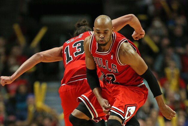 CHICAGO, IL - FEBRUARY 13: Taj Gibson #22 and Joakim Noah #13 of the Chicago Bulls celebrate during a time-out against the Brooklyn Nets at the United Center on February 13, 2014 in Chicago, Illinois. The Bulls defeated the Nets 92-76. NOTE TO USER: User expressly acknowledges and agrees that, by downloading and or using this photograph, User is consenting to the terms and conditions of the Getty Images License Agreement. (Photo by Jonathan Daniel/Getty Images)