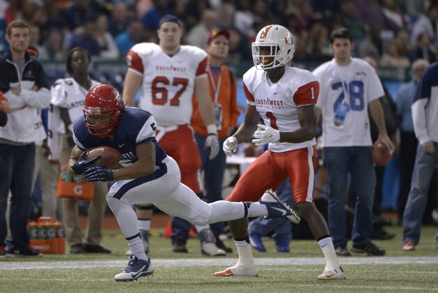 West defensive back Shaquille Richardson (5), of Arizona, intercepts a pass intended for East receiver Allen Hurns (1), of Miami, during the first half of the East-West Shrine Classic NCAA football game in St. Petersburg, Fla., Saturday, Jan. 18, 2014.(AP Photo/Phelan M. Ebenhack)
