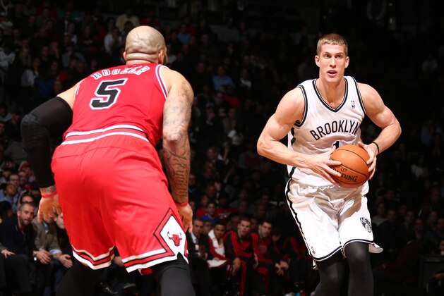 BROOKLYN, NY - MARCH 3: Mason Plumlee #1 of the Brooklyn Nets passes against Carlos Boozer #5 of the Chicago Bulls during a game at the Barclays Center on March 3, 2014 in the Brooklyn borough of New York City.  NOTE TO USER: User expressly acknowledges and agrees that, by downloading and/or using this Photograph, user is consenting to the terms and conditions of the Getty Images License Agreement. Mandatory Copyright Notice: Copyright 2014 NBAE (Photo by Nathaniel S. Butler/NBAE via Getty Images)