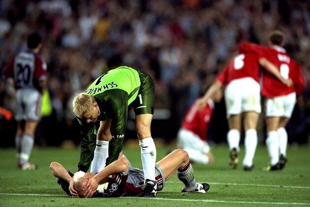 26 May 1999:  Peter Schmeichel of Manchester United consoles Carsten Jancker of Bayern Munich after United beat Bayern in the European Champions League Final in the Nou Camp Stadium, Barcelona, Spain. Manchester United won 2 - 1 with both United goals scored during injury time, to secure the treble of League, FA Cup and European Cup. \ Mandatory Credit: Shaun Botterill /Allsport