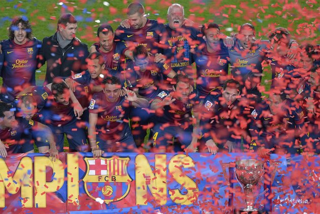 FC Barcelona's players celebrate after winning the Spanish League after their La Liga soccer match against Valladolid at Camp Nou stadium in Barcelona, Sunday, May 19, 2013. (AP Photo/Manu Fernandez)