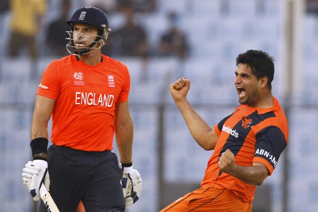 Netherlands's Mudassar Bukhari, right, celebrates the wicket of England's Michael Lumb, left, during their ICC Twenty20 Cricket World Cup match in Chittagong, Bangladesh, Monday, March 31, 2014. (AP Photo/A.M. Ahad)
