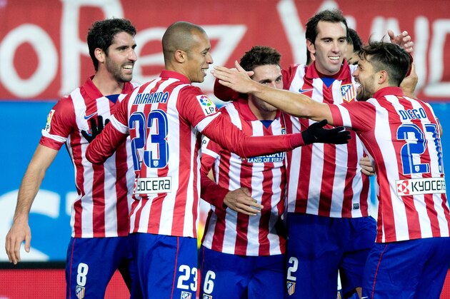 MADRID, SPAIN - FEBRUARY 02: Joao Miranda (2ndL) celebrates scoring their third goal with teammates Diego Ribas (R), Diego Godin (2ndR), Koke (3dR) and Raul Garcia (L) during the La Liga match between Club Atletico de Madrid and Real Sociedad de Futbol at Vicente Calderon Stadium on February 2, 2014 in Madrid, Spain.  (Photo by Gonzalo Arroyo Moreno/Getty Images)