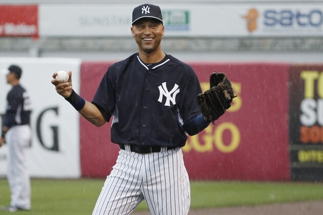 New York Yankees Derek Jeter laughs as he throws in the rain before a spring exhibition baseball game against the Miami Marlins was canceled due to the weather in Tampa, Fla., Saturday, March 29, 2014. (AP Photo/Kathy Willens)