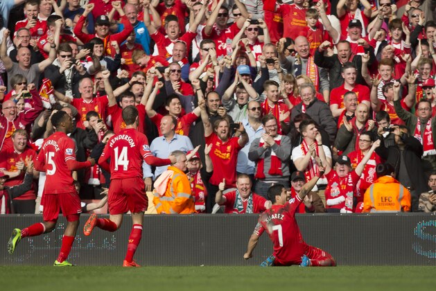 Liverpool's Luis Suarez , right, celebrates after scoring against Tottenham during their English Premier League soccer match at Anfield Stadium, Liverpool, England, Sunday March 30, 2014. (AP Photo/Jon Super)