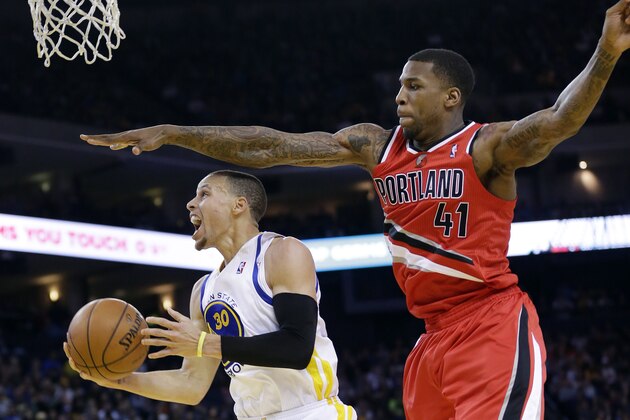 Golden State Warriors' Stephen Curry (30) drives past Portland Trail Blazers' Thomas Robinson (41) during the second half of an NBA basketball game on Sunday, Jan. 26, 2014, in Oakland, Calif. Golden State won 103-88. (AP Photo/Marcio Jose Sanchez)