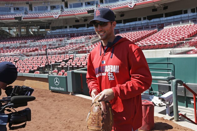 St. Louis Cardinals starting pitcher Adam Wainwright walks onto the field at the start of batting practice on Sunday, March 30, 2014, in Cincinnati. Wainwright will be the starting pitcher for the Cardinals in Monday's Opening Day baseball game against the Cincinnati Reds in Cincinnati. (AP Photo/Al Behrman)