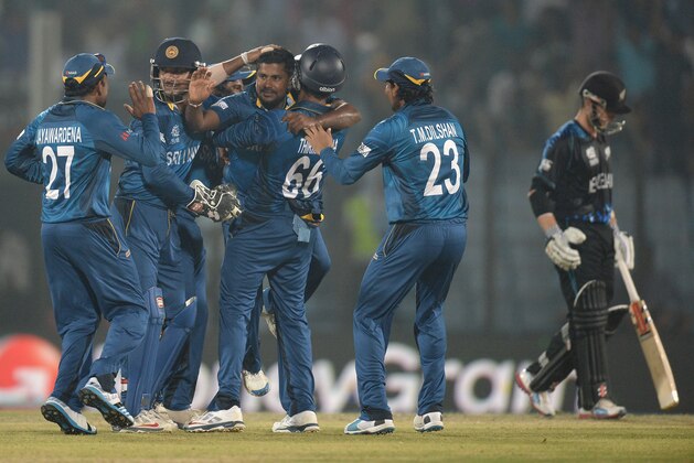 CHITTAGONG, BANGLADESH - MARCH 31:  Rangana Herath of Sri Lanka celebrates with teammates after dismissing Jimmy Neesham of New Zealand during the ICC World Twenty20 Bangladesh 2014 Group 1 match between Sri Lanka and New Zealand at Zahur Ahmed Chowdhury Stadium on March 31, 2014 in Chittagong, Bangladesh.  (Photo by Gareth Copley/Getty Images)