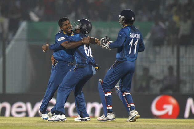 Sri Lanka's Rangana Herath, left, celebrates with his teammates the wicket of New Zealand's captain Brendon McCullum during their ICC Twenty20 Cricket World Cup match in Chittagong, Bangladesh, Monday, March 31, 2014. (AP Photo/A.M. Ahad)