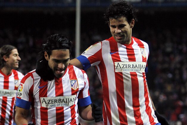 Atletico de Madrid's Radamel Falcao from Colombia, center, celebrates his goal with Diego Costa from Brazil, right, and Filipe Luis from Brazil, left, during a Spanish La Liga soccer match against Deportivo la Coruna at Vicente Calderon stadium in Madrid, Spain, Sunday, Dec. 9, 2012. (AP Photo/Andres Kudacki)