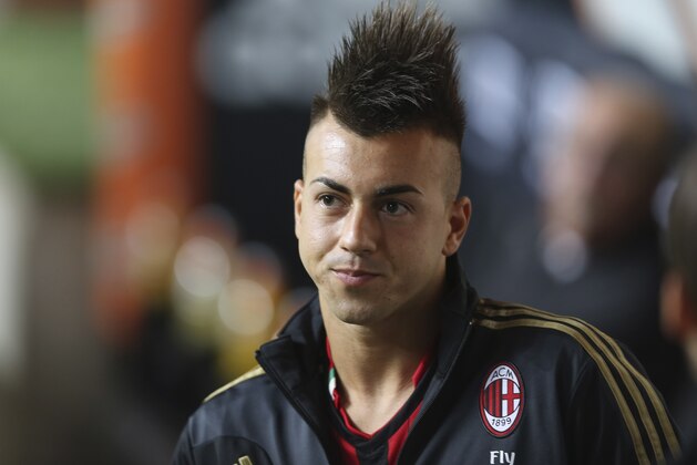 AC Milan forward Stephan El Shaarawy watches from the bench during a Serie A soccer match between AC Milan and Cagliari, at the San Siro stadium in Milan, Italy, Sunday, Sept.1, 2013. (AP Photo/Luca Bruno)