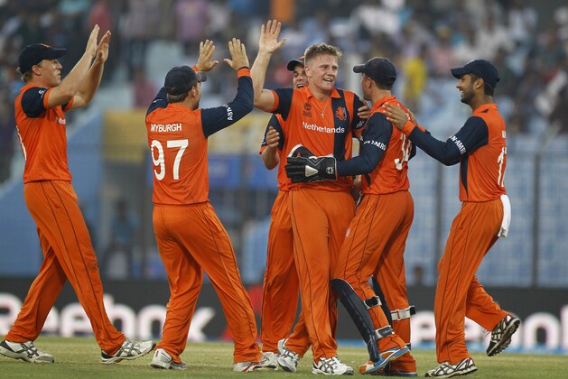 Netherlands's Timm van der Gugten, third right, celebrates with his teammates  the wicket of England's Eoin Morgan during their ICC Twenty20 Cricket World Cup match in Chittagong, Bangladesh, Monday, March 31, 2014. (AP Photo/A.M. Ahad)