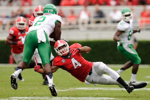 Sep 21, 2013; Athens, GA, USA; Georgia Bulldogs cornerback Brendan Langley (4) tackles North Texas Mean Green running back Reggie Pegram (2) during the first half at Sanford Stadium. Georgia defeated North Texas 45-21. Mandatory Credit: Dale Zanine-USA TODAY Sports