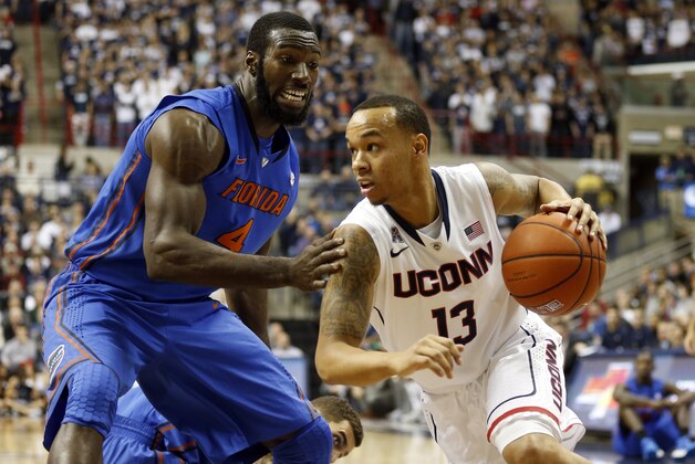 Dec 2, 2013; Storrs, CT, USA; Connecticut Huskies guard Shabazz Napier (13) drives the ball against Florida Gators center Patric Young (4) in the first half at Harry A. Gampel Pavilion. Mandatory Credit: David Butler II-USA TODAY Sports Dec 2, 2013; Storrs, CT, USA; Connecticut Huskies guard Shabazz Napier (13) drives the ball against Florida Gators center Patric Young (4) in the first half at Harry A. Gampel Pavilion. Mandatory Credit: David Butler II-USA TODAY Sports