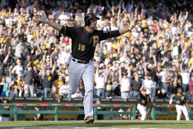 PITTSBURGH, PA - MARCH 31:  Neil Walker #18 of the Pittsburgh Pirates celebrates after hitting a walk off solo home run in the tenth inning against the Chicago Cubs during Opening Day at PNC Park March 31, 2014 in Pittsburgh, Pennsylvania.  (Photo by Justin K. Aller/Getty Images)