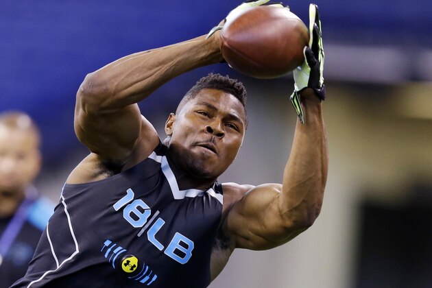 Buffalo linebacker Khalil Mack makes a catch as he runs a drill at the NFL football scouting combine in Indianapolis, Monday, Feb. 24, 2014. (AP Photo/Michael Conroy)